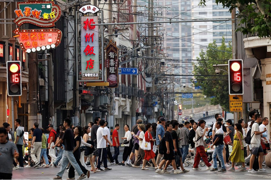 People walk past a lane lined up with restaurants, at a shopping area in Shanghai, China September 28, 2024.