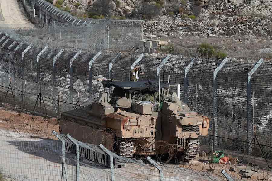 An Israeli soldier conducting morning prayers on a Namer Armoured Personnel Carrier (APC), along the Golan Heights side of the ceasefire line between Syria and the Israeli-occupied Golan Heights, on Tuesday –Reuters photo