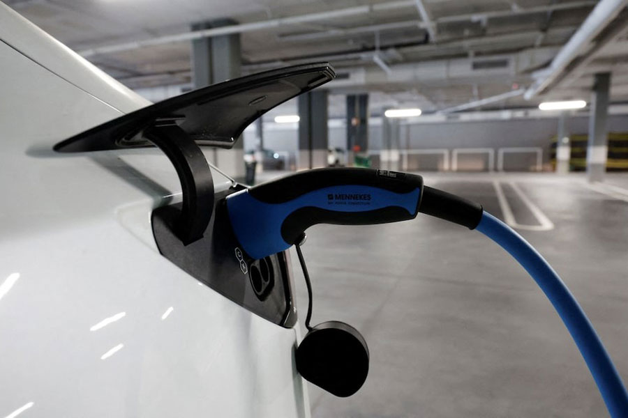 A Tesla electric vehicle is plugged to a charger in a parking lot in Teia, north of Barcelona, Spain, October 31, 2023.