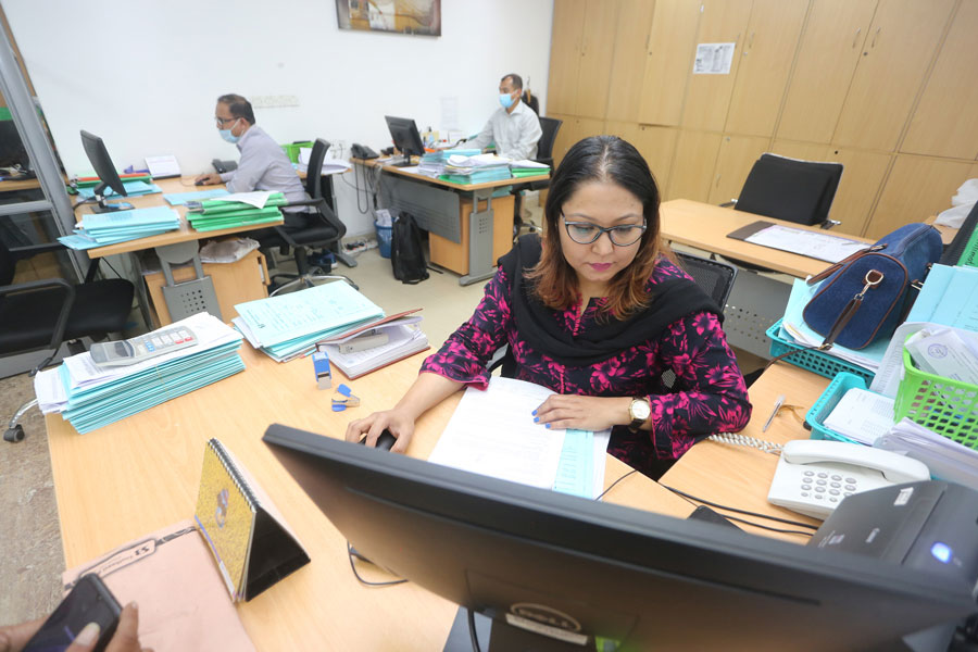 A woman working at a bank branch in Dhaka