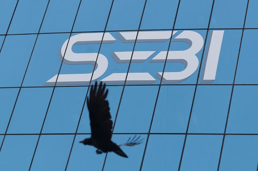 A bird flies past the new logo of the Securities and Exchange Board of India (SEBI) at its headquarters in Mumbai, India on April 19, 2023 — Reuters/Files