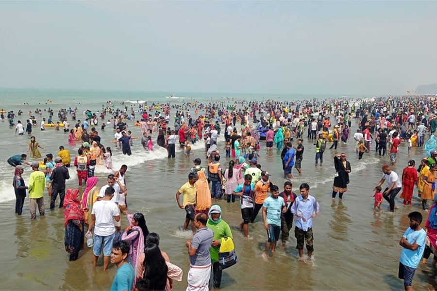 Millions of tourists were seen enjoying in the salty sea at Sugandha point at Cox's Bazar beach on Tuesday