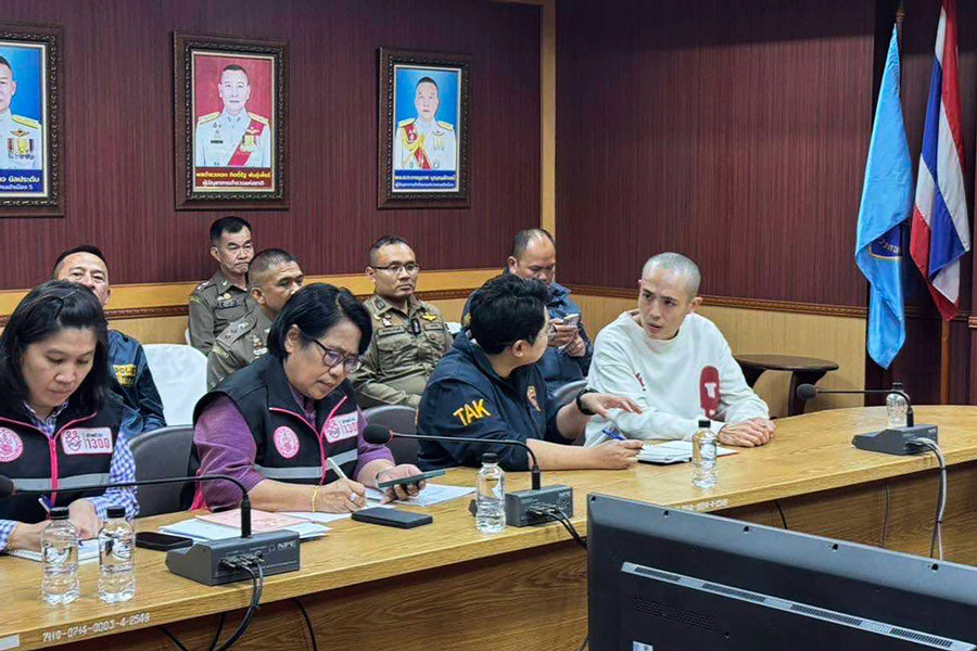 In this image provided by the Royal Thai Police, Chinese actor Wang Xing, right, talks with Thai police officers in Mae Sot district, in Thai-Myanmar border, Tak province Tuesday, Jan. 7, 2025.