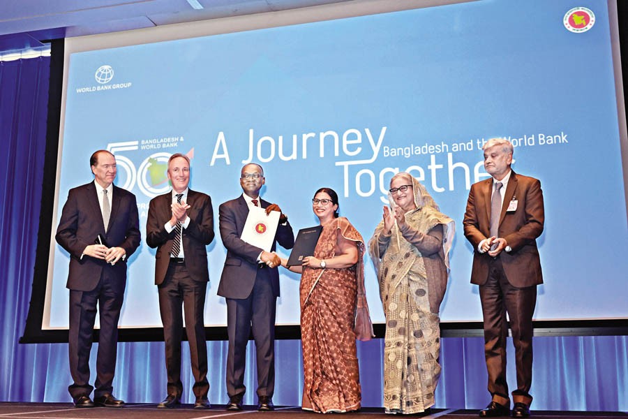 Prime Minister Sheikh Hasina and WB President David Malpass witness the exchange of documents of a loan agreement at an event in Washington, DC on Monday. — Focus Bangla