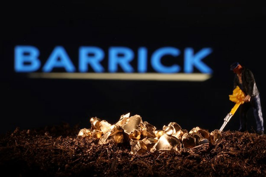 A small toy figure and gold imitation are seen in front of the Barrick logo in this illustration taken November 19, 2021.
