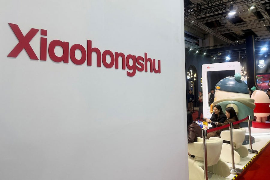 People sit at the booth for Xiaohongshu app at the China International Import Expo (CIIE) in Shanghai, China November 6, 2024.