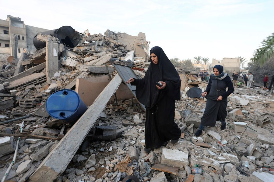 Palestinians inpsect the site of an Israeli strike on a house, amid the ongoing conflict between Israel and Hamas, in Deir Al-Balah in the central Gaza Strip, January 15, 2025.