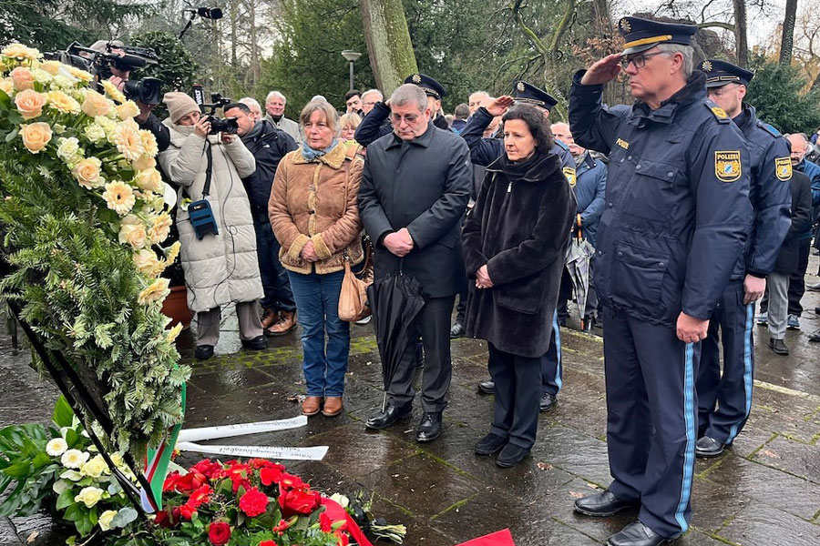 Police salutes in front of a wreath the day after two people, one a child, were killed in a knife attack, in Aschaffenburg, Germany, January 23, 2025.