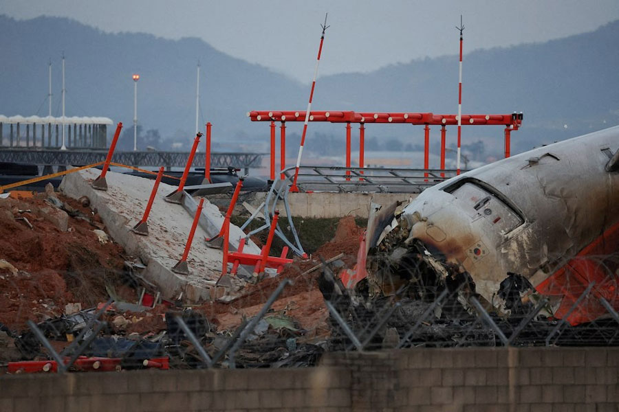 The wreckage of the Jeju Air aircraft that went off the runway and crashed at Muan International Airport lies near a concrete structure it crashed into, in Muan, South Korea, December 30, 2024.