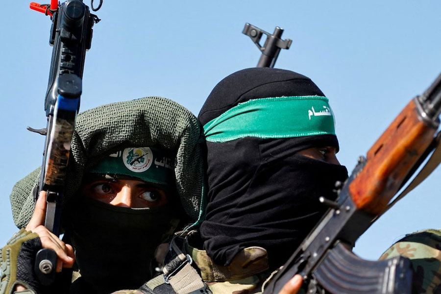 Palestinian fighters from the armed wing of Hamas take part in a military parade to mark the anniversary of the 2014 war with Israel, in the central Gaza Strip, July 19, 2023.