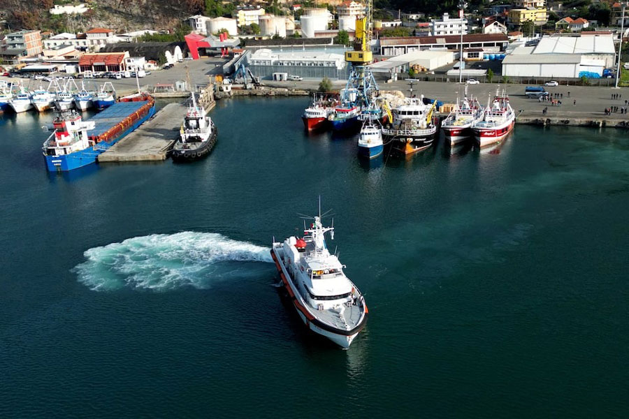 A drone view shows an Italian coast guard vessel departing for Italy with migrants, who were intercepted at sea and later detained at a reception facility in Albania, after a court in Rome overturned their detention orders, in Shengjin, Albania, October 19, 2024.
