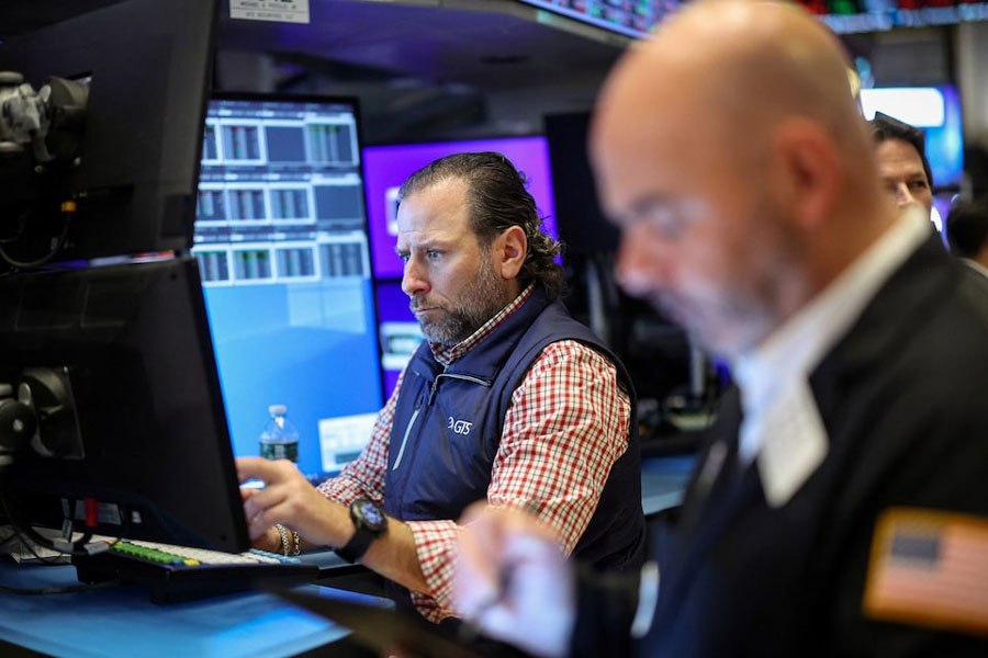 Traders work on the floor at the New York Stock Exchange (NYSE) in New York City, US, December 10, 2024.