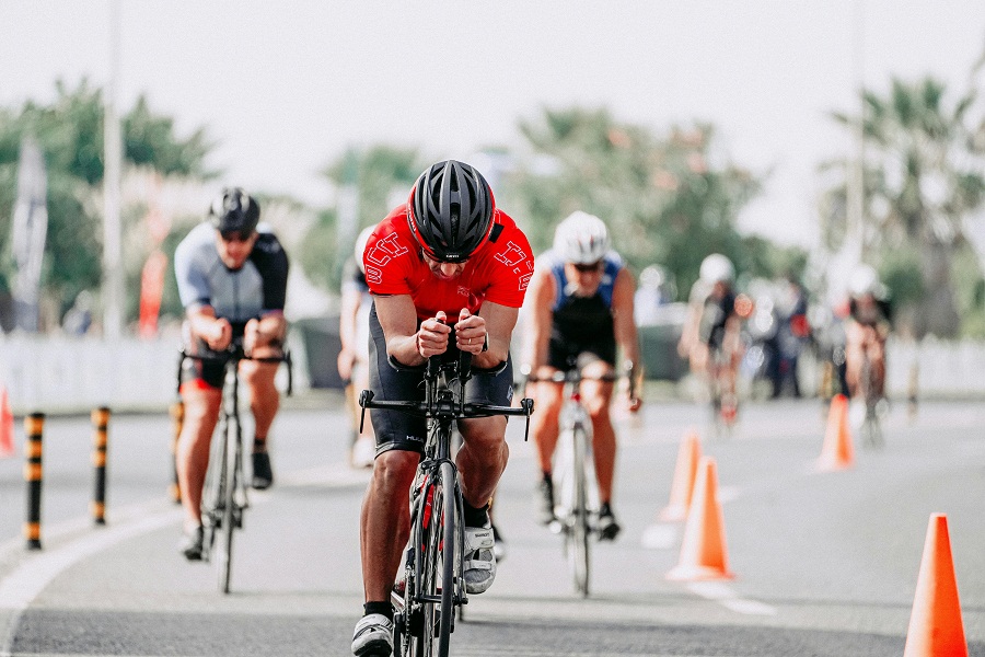 Cyclists riding bikes on road during race