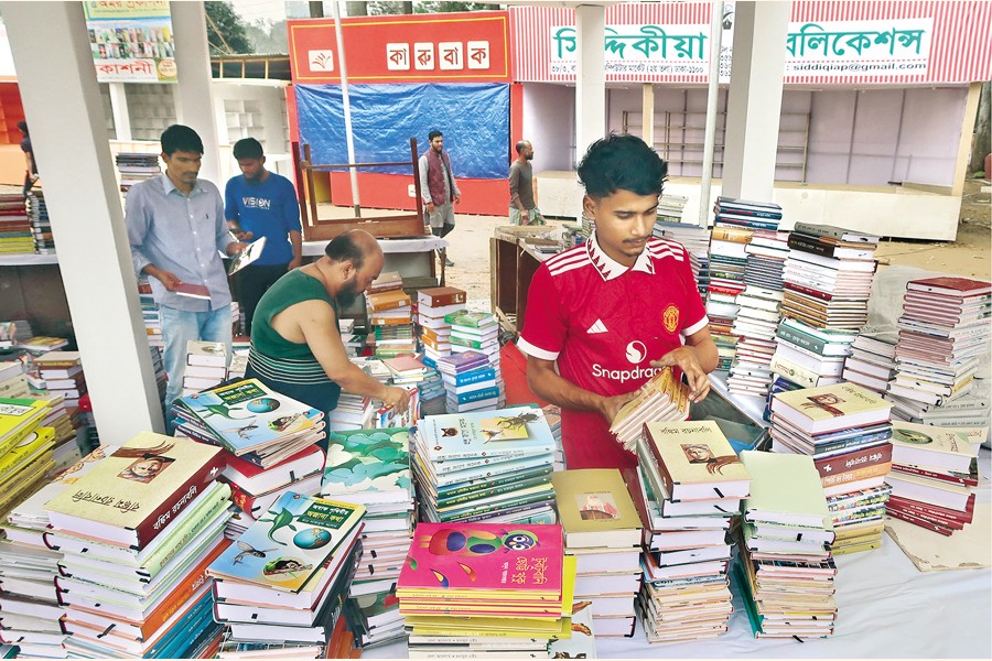 Book stalls and pavilions are busy furnishing their facilities at the last minute as curtain of a month-long book fair rises at Bangla Academy in the capital today (Saturday). The snap was shot at Suhrawardy Udyan. — FE Photo