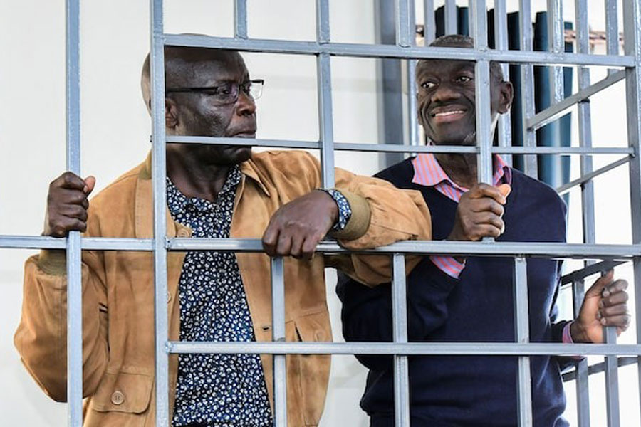 Opposition leader Kizza Besigye and Obeid Lutale stand in a steel dock at the Uganda Military General Court Martial in Makindye, a suburb of Kampala, Uganda December 2, 2024.