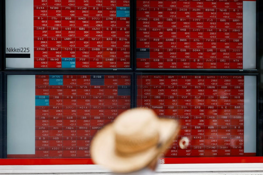 A man looks at an electronic board displaying the Nikkei stock average outside a brokerage in Tokyo, Japan, August 6, 2024.