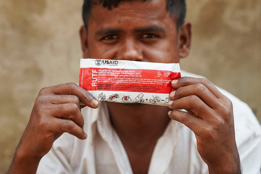 Muhammad Shukkur, 35, a Rohingya man, poses for a picture with a nutrition supplement packet, that has been provided by USAID among Rohingya refugees, in Cox’s Bazar, Bangladesh, February 5, 2025.