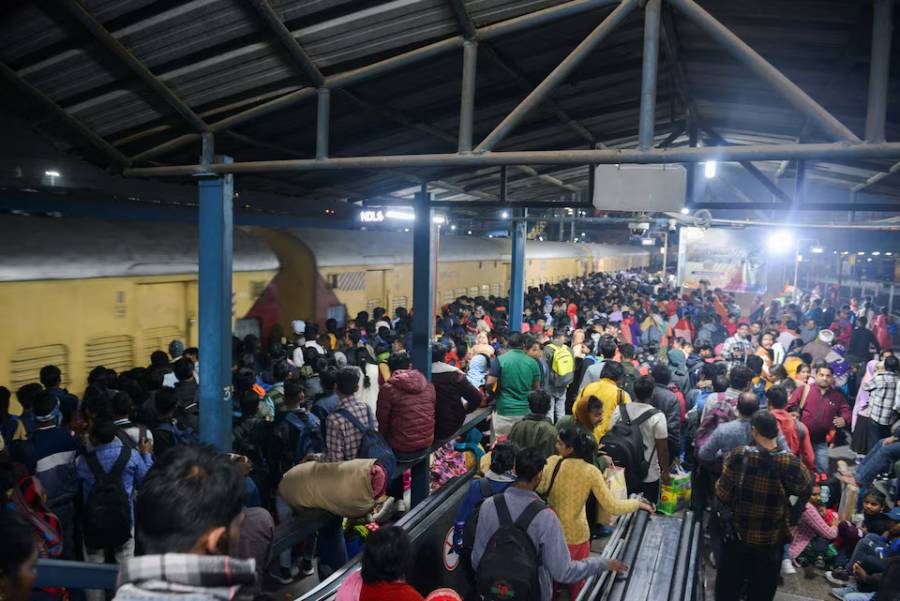 People, including Hindu pilgrims on their way to attend the "Maha Kumbh Mela", or the Great Pitcher Festival, gather at the New Delhi Railway Station to board a train in New Delhi, India, February 15, 2025.