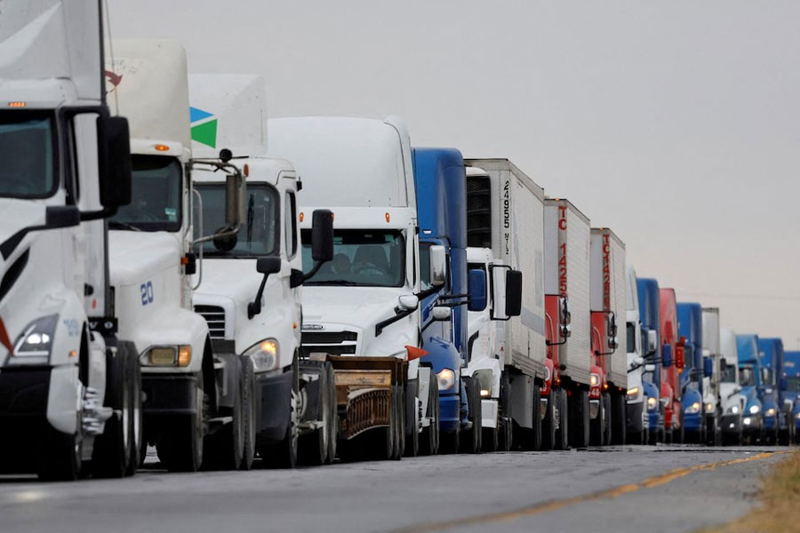 Trucks wait in line to cross into the United States near the border customs control at the World Trade Bridge, in Nuevo Laredo, Mexico, November 26, 2024.
