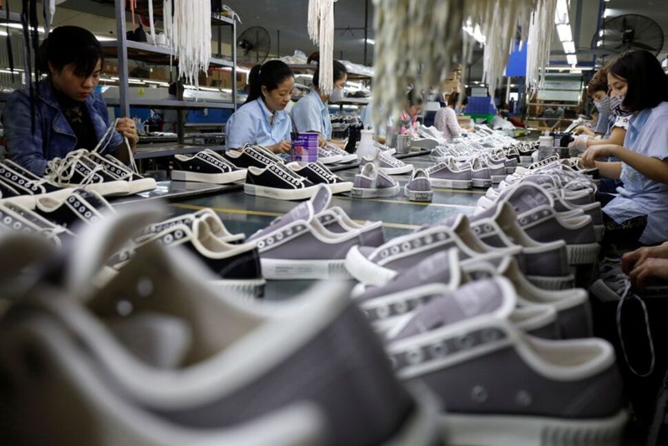 Employees work at a shoe factory for export in Hanoi, Vietnam December 29, 2020. REUTERS/Kham/File Photo