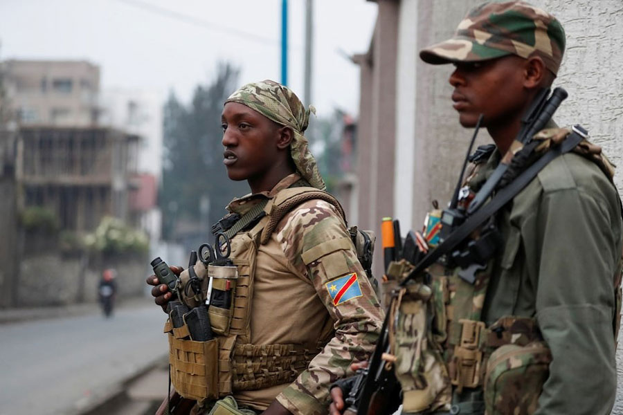 Members of the M23 rebel group stand guard, outside, at their position amid conflict between them and the Armed Forces of the Democratic Republic of the Congo (FARDC), in Goma, eastern Democratic Republic of the Congo, January 29, 2025.