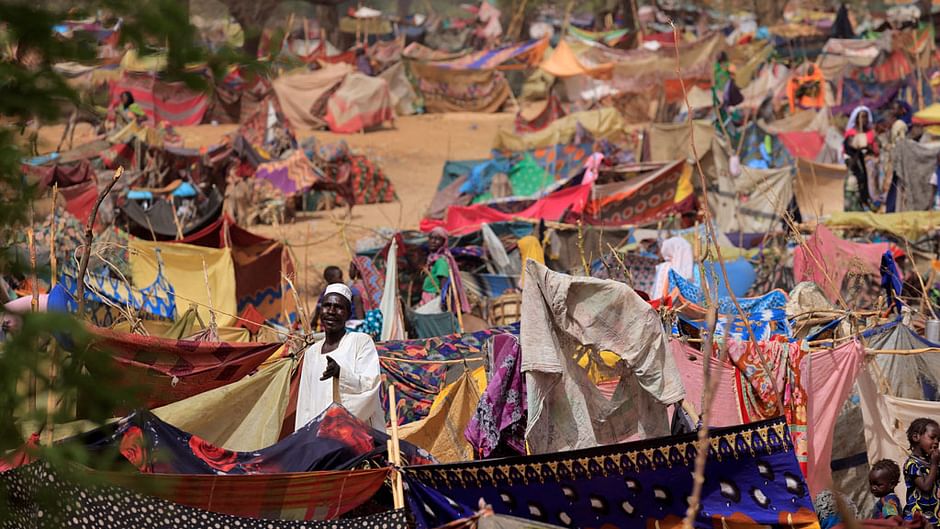 A sudanese man who fled the conflict in Sudan's Darfur region, and was previously internally displaced in Sudan, reacts as he talks with relatives at his makeshift shelter near the border between Sudan and Chad, while taking refuge in Borota, Chad, May 13, 2023. |REUTERS/Zohra Bensemra