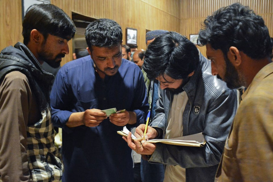 Passengers who were rescued from a train after it was attacked by separatist militants, get themselves registered at the Railway Station in Quetta, Balochistan, Pakistan, March 12, 2025.