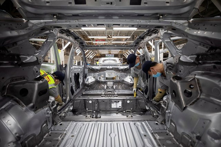 Employees work on an electric vehicle (EV) production line at a Volkswagen Anhui factory in Hefei, Anhui province, China September 25, 2024.