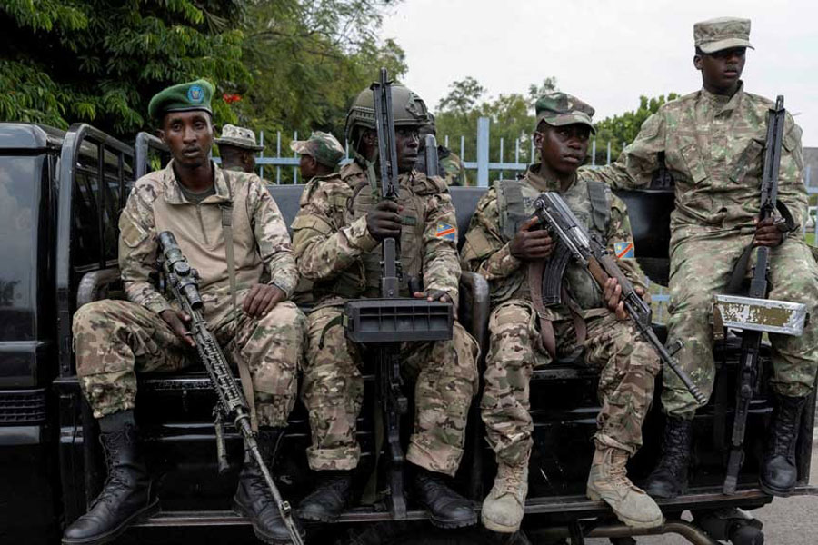 M23 rebels sit on a truck during the escort of captured FDLR members (not pictured) to Rwanda for repatriation, at the Goma-Gisenyi Grande Barrier border crossing, Mar 1, 2025.