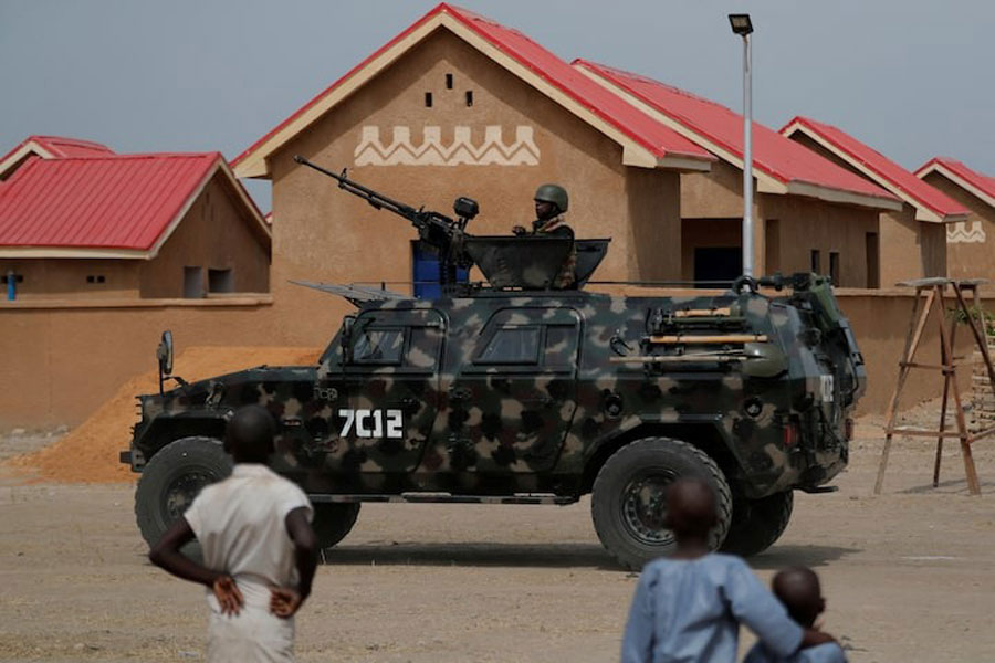 An armored vehicle of Nigerian Security Forces drives by newly built homes, ahead of the community re-opening ceremony which was destroyed by Boko Haram armed militants in 2015, in Ngarannam, Borno State, Nigeria, October 21, 2022.