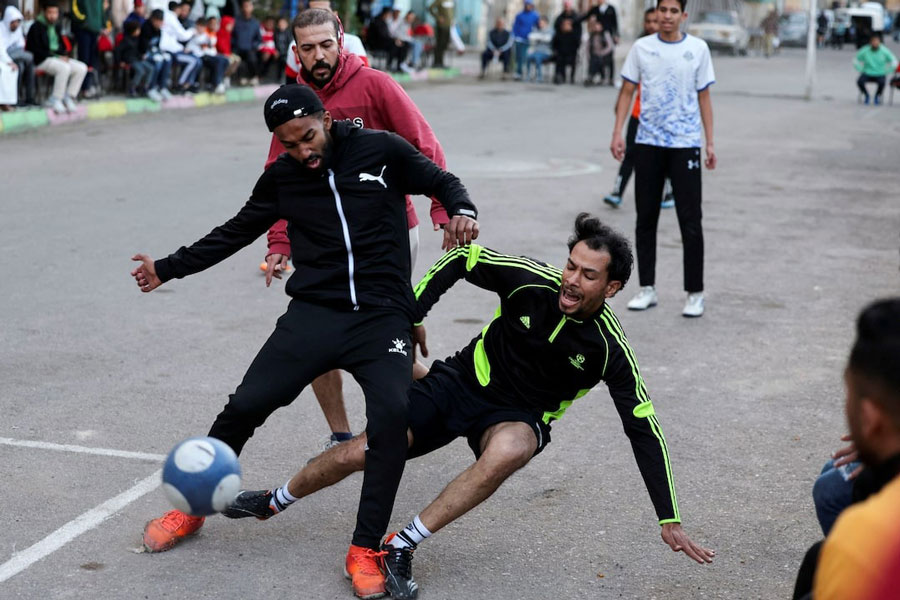 Players take part in a 'Sock Ball' match during a Ramadan soccer tournament held on a street in Alexandria, Egypt, March 23, 2025.