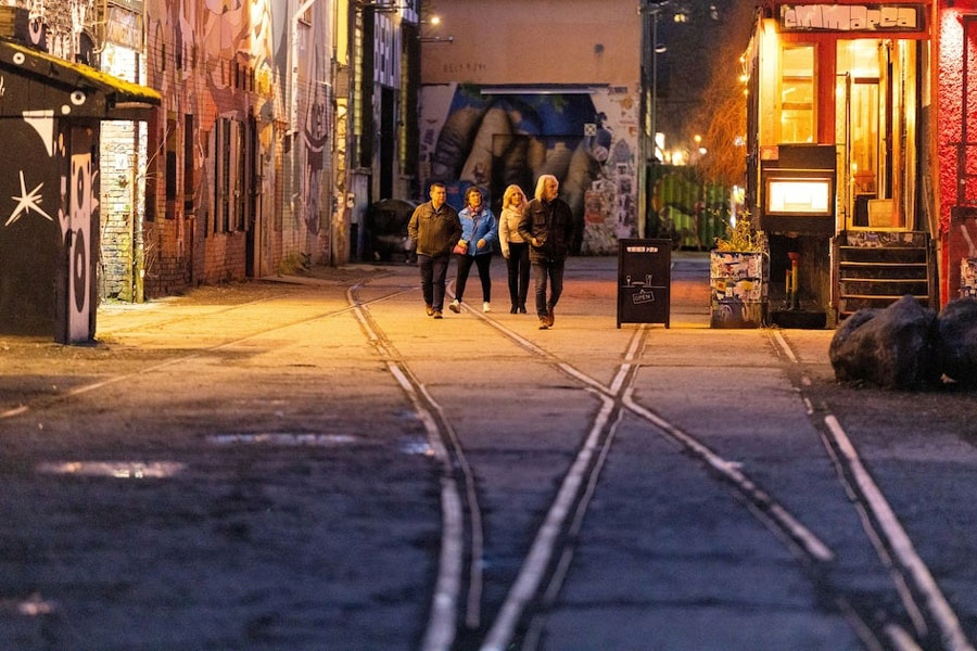People walk along bars and clubs at RAW site, a former industrial rail maintenance plant, in Berlin, Germany, March 27, 2025.