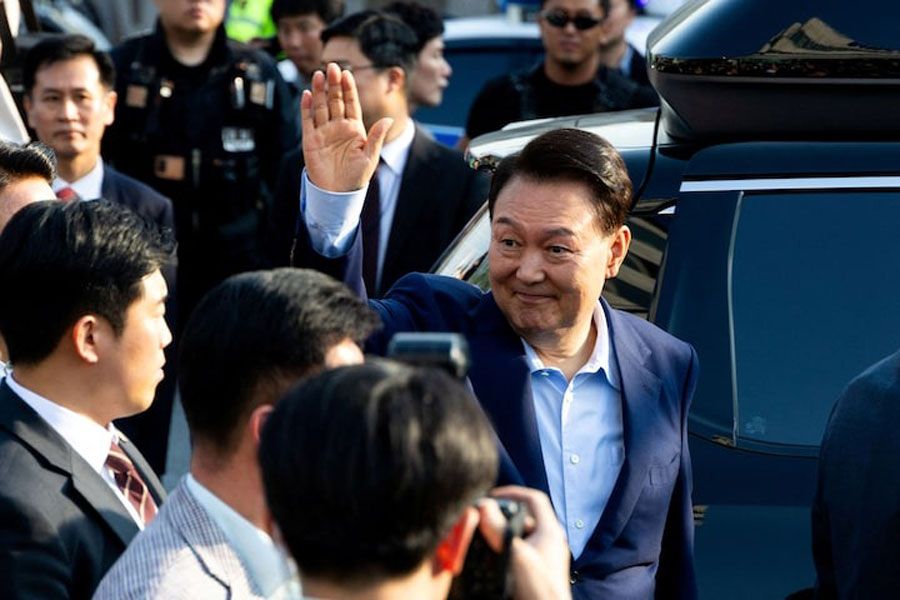 Ousted former South Korean President Yoon Suk Yeol waves to his supporters as he moves out of the presidential residence in Seoul, South Korea, April 11, 2025.