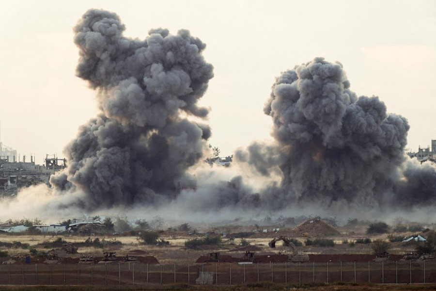 Smoke rises from Gaza after an explosion, as seen from the Israeli side of the border, April 14, 2025.