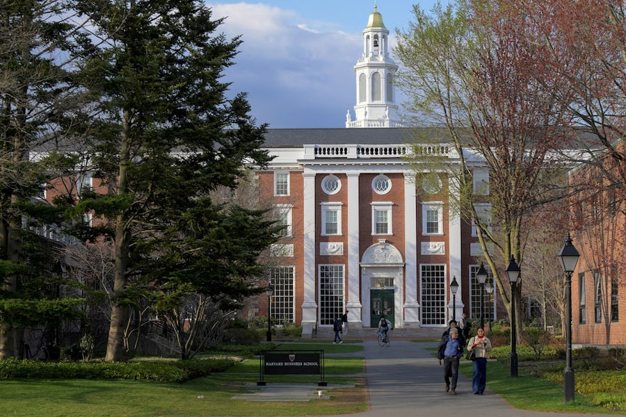 People walk on the Business School campus of Harvard University in Cambridge, Massachusetts, US, April 15, 2025.
