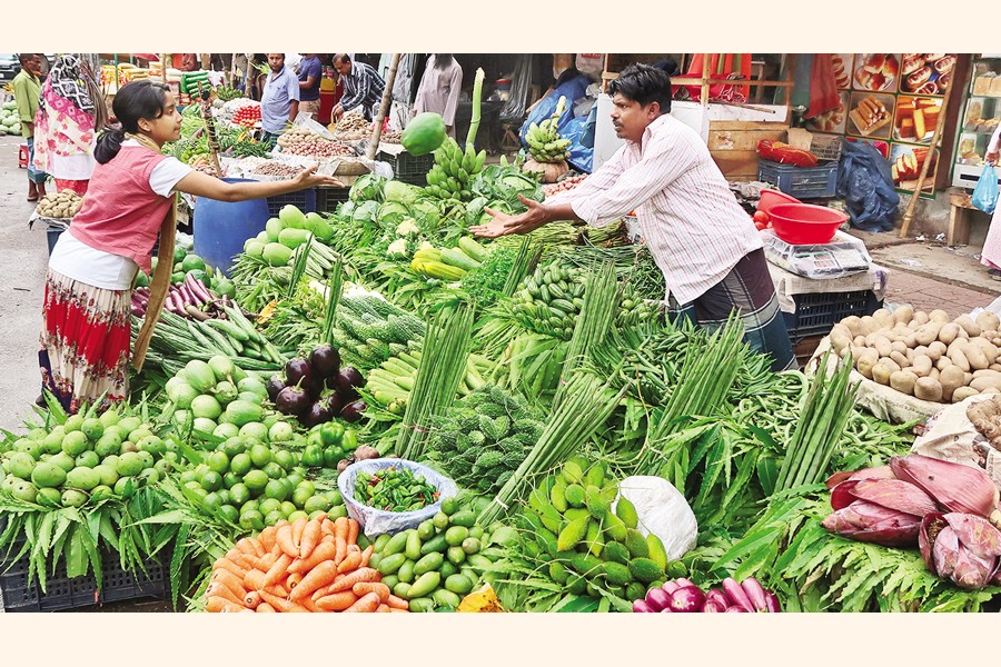A customer buying a vegetable item from a vendor at Motijheel in the capital on Friday. Prices of the summer vegetables have become exorbitantly high in the markets in recent time after the winter season ones have taken adieu