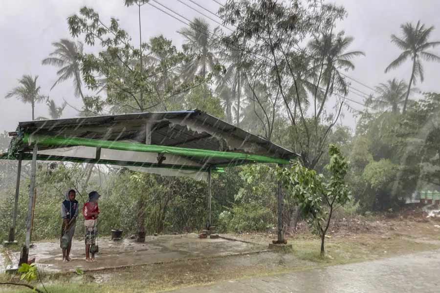 Two children standing under a roadside shelter to protect from rain before Cyclone Mocha hits in Rakhine State in Myanmar on May 14 this year – AP file photo