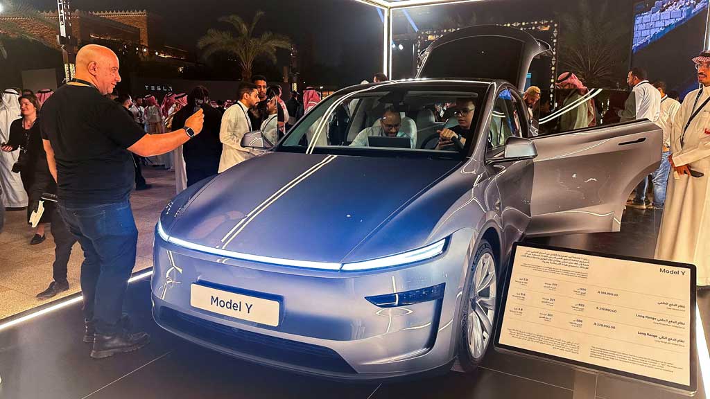 A guest takes photos of Tesla Model Y, displayed during the inauguration ceremony of the first Tesla showroom in Riyadh, Saudi Arabia. April 10, 2025. REUTERS