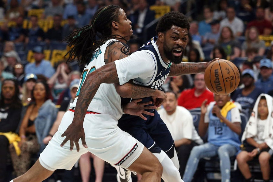 Memphis, Tennessee, USA; Dallas Mavericks forward Naji Marshall (13) drives to the basket against Memphis Grizzlies guard Ja Morant (12) during the first quarter at FedExForum.