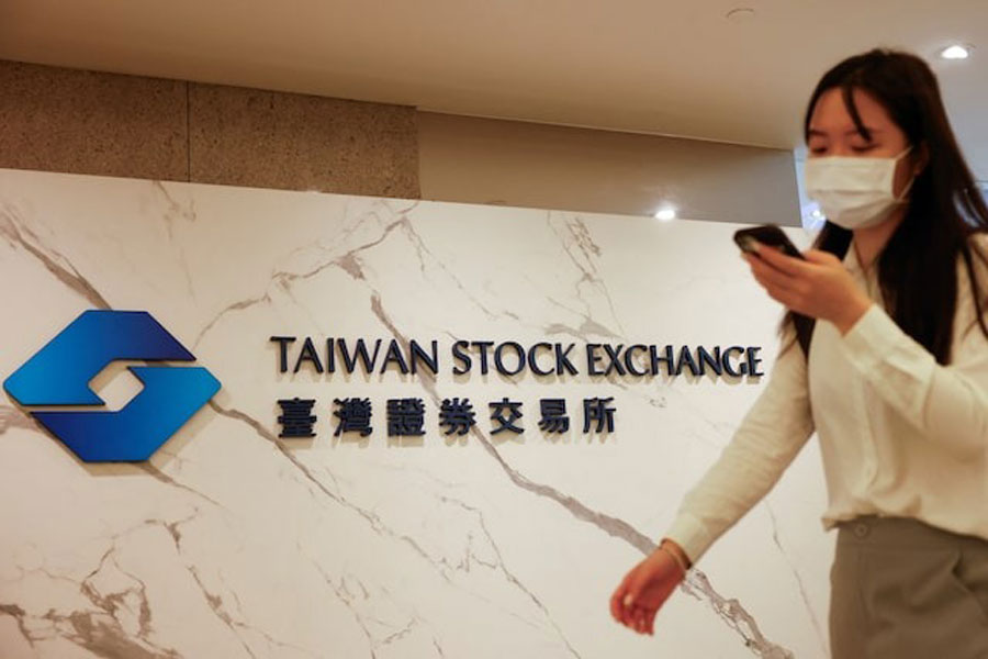 A woman walks past Taiwan Stock Exchange logo outside their office in Taipei, Taiwan August 6, 2024.