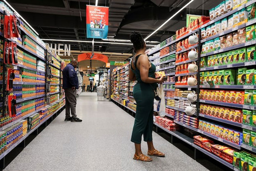 Shoppers look for items as they shop at an outlet of retailer Checkers in Sandton City mall, in Sandton, South Africa, August 28, 2024.