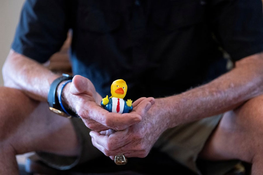 Steve Egan, owner of a custom promotional items business, holds a US President Donald Trump-themed rubber duck as he poses for a portrait during an interview with Reuters in Brandon, Florida, US, April 22, 2025.