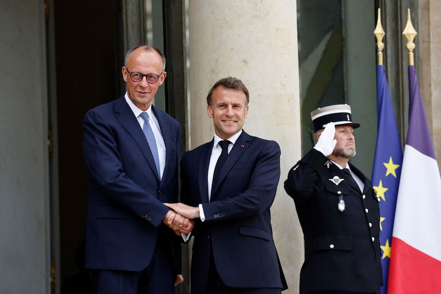 French President Emmanuel Macron shakes hands with newly elected German Chancellor Friedrich Merz as he arrives for a meeting at the Elysee Palace in Paris, France, May 7, 2025.