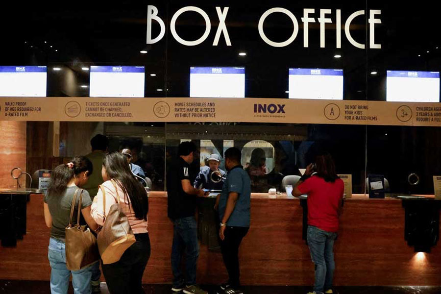 People wait in queue to purchase movie tickets at an INOX multiplex cinema hall inside a shopping mall in Kolkata, India, Feb 22, 2024.