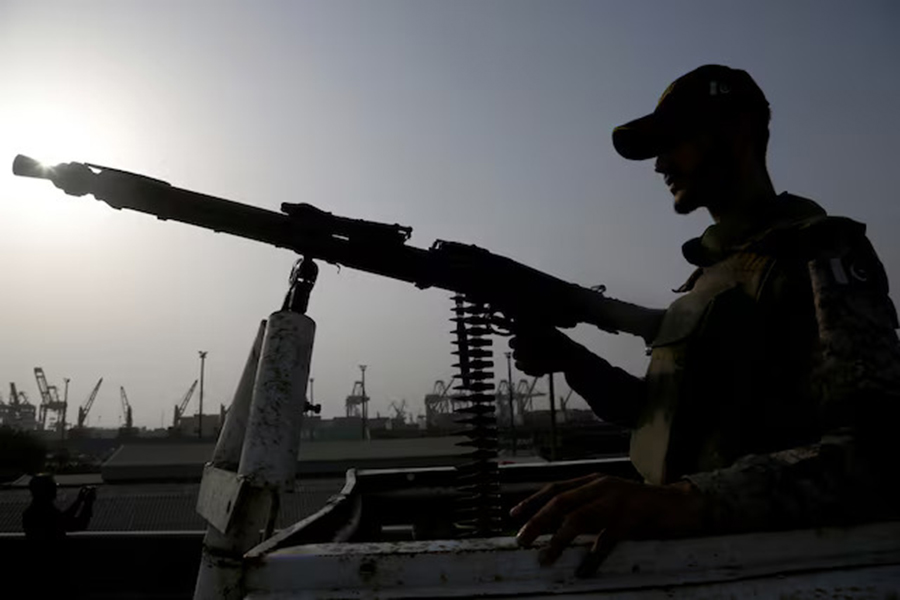 A paramilitary trooper mans a gun atop a vehicle as he keeps guard during a media tour of the Karachi Port, Pakistan on May 9, 2025 — Reuters photo
