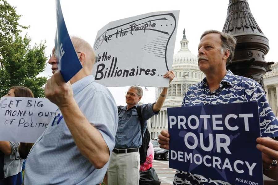 Supporters look on at a news conference led by Democratic senators and congressmen in support of a proposed constitutional amendment for campaign finance reform, on Capitol Hill in Washington September 08, 2014. —Reuters