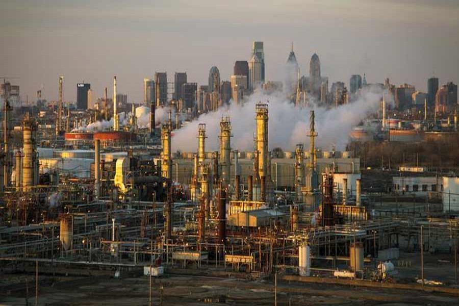 The Philadelphia Energy Solutions oil refinery owned by The Carlyle Group is seen at sunset in front of the Philadelphia skyline. — Reuters