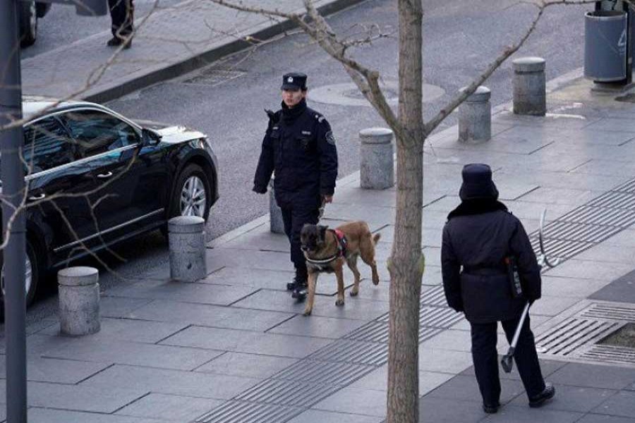 Police patrol outside the Joy City Mall in the Xidan district after a knife attack, in Beijing, China February 11, 2018. - Reuters