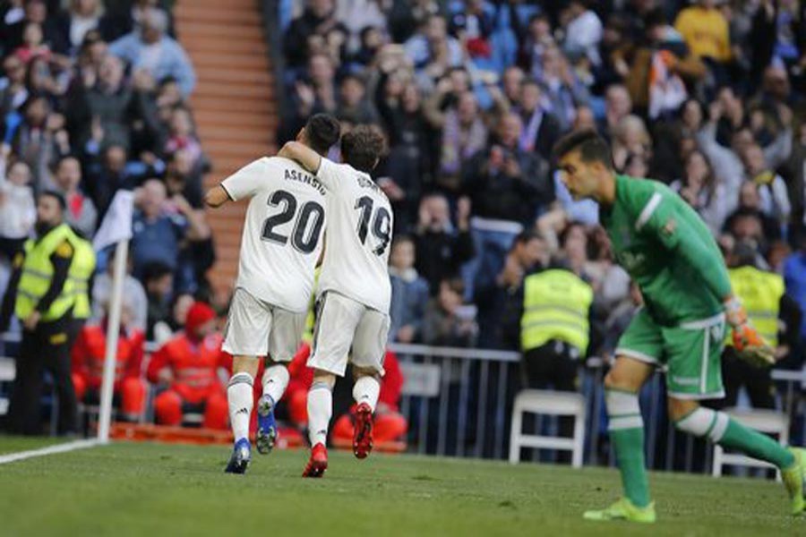 Real Madrid's Marco Asensio, left, celebrating with Alvaro Odriozola after scoring the opening goal during a round of 32, 2nd leg, Spanish Copa del Rey football match between Real Madrid and Melilla at the Santiago Bernabeu stadium at Madrid in Spain on Thursday — AP