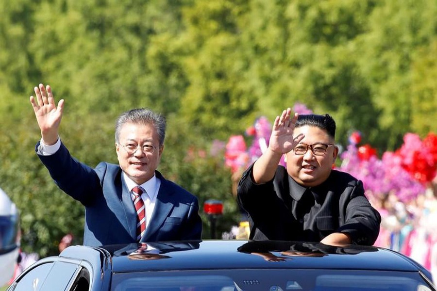 A file photo showing South Korean President Moon Jae-in (left) and North Korean leader Kim Jong Un waving during a car parade in Pyongyang, North Korea recently — Reuters